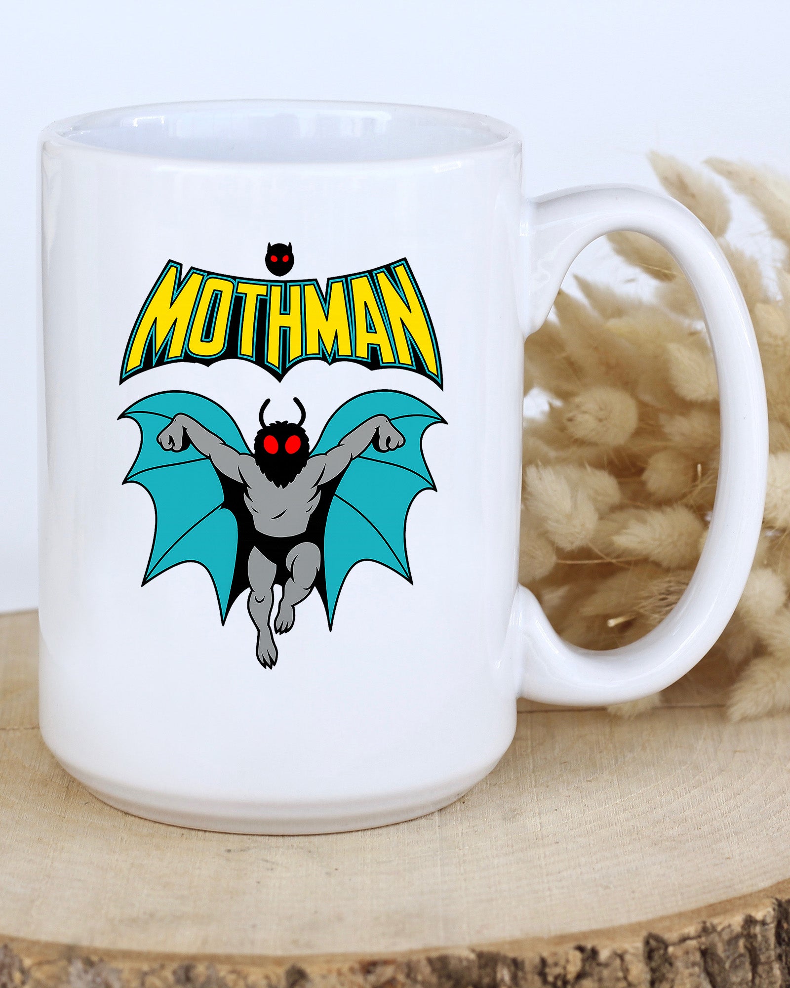 Ceramic mug featuring a cartoon-style Mothman with glowing red eyes and wings under the word MOTHMAN.