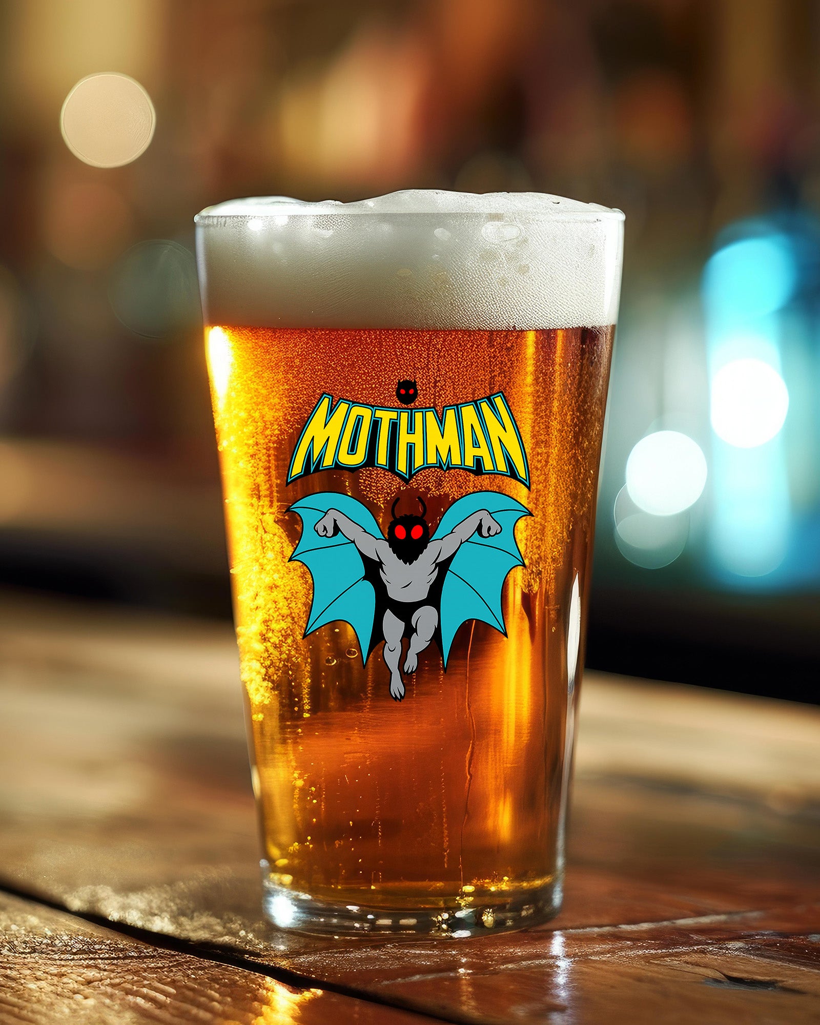 Glass pint glass featuring a cartoon-style Mothman with glowing red eyes and wings under the word MOTHMAN.