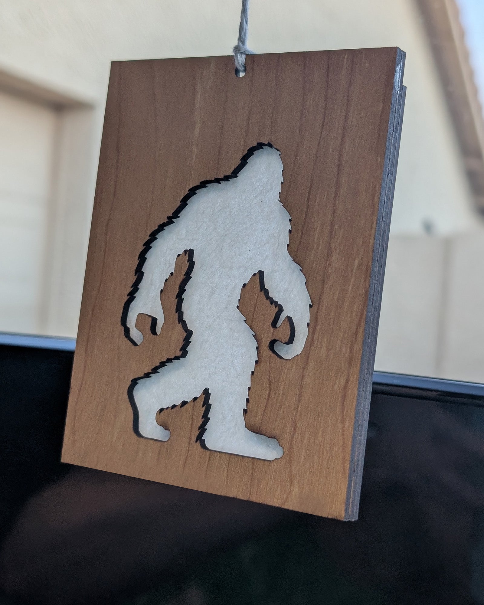 Wooden air freshener made from Baltic birch featuring a Bigfoot silhouette with a felt insert for scent.
