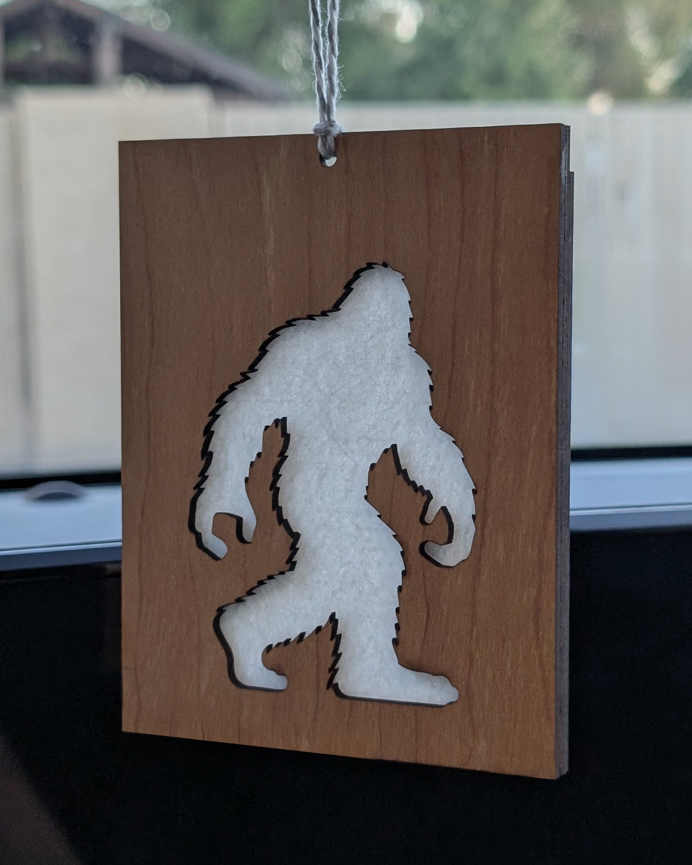 Wooden air freshener made from Baltic birch featuring a Bigfoot silhouette with a felt insert for scent.